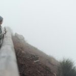 Girl climbs the path to the mountain